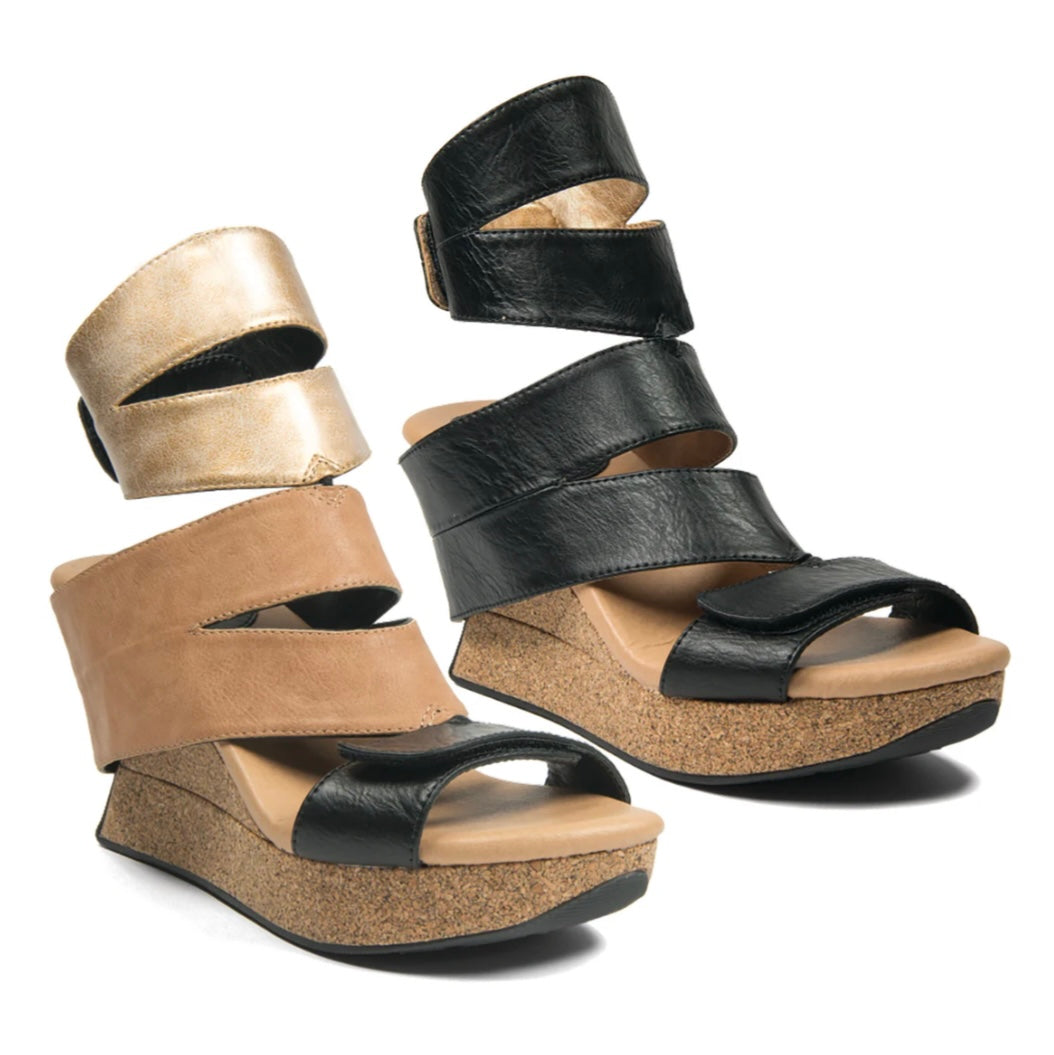 Pair of wedge sandals in black and beige close-up