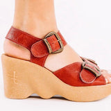 Red wedge sandal with honey sole and brass buckle closure