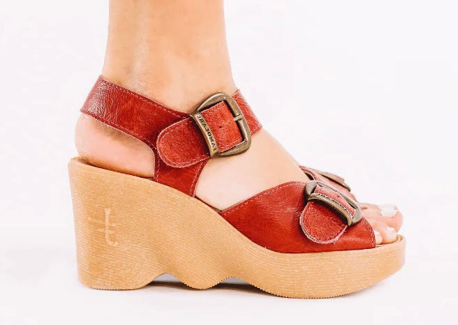 Red wedge sandal with honey sole and brass buckle closure