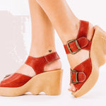 Red wedge sandal with honey sole and brass buckle closure side view