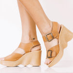 Tan wedge sandal with honey sole and brass buckle closure model
