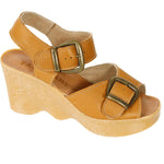 Tan wedge sandal with honey sole and brass buckle closure side view