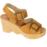 Tan wedge sandal with honey sole and brass buckle closure side view