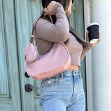 Pink handbag with a shoulder strap and hand strap and small accessory bag model