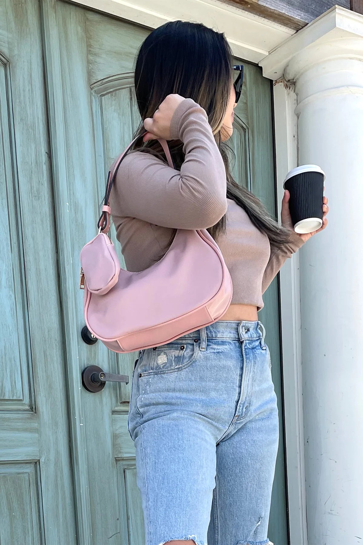 Pink handbag with a shoulder strap and hand strap and small accessory bag model