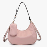 Pink handbag with a shoulder strap and hand strap and small accessory bag close-up