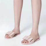 Light pink flat sandal with bow embellishment model