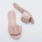 Light pink flat sandal with bow embellishment top & side view