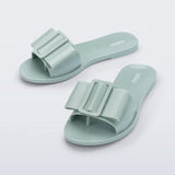 Light turquoise flat sandal with bow embellishment top view