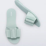 Light turquoise flat sandal with bow embellishment top & side view