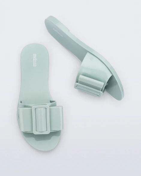 Light turquoise flat sandal with bow embellishment top & side view
