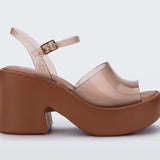 Brown platform sandal with translucent straps and buckle closure close-up