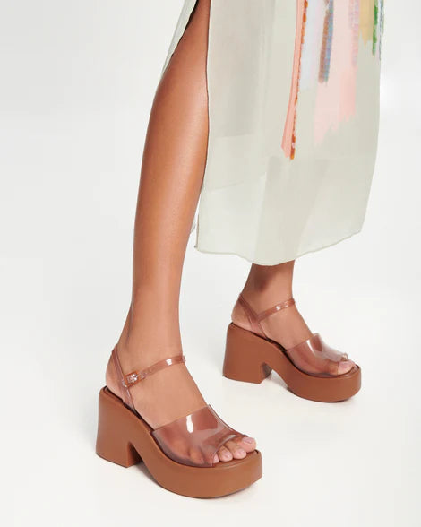 Brown platform sandal with translucent straps and buckle closure model