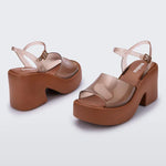 Brown platform sandal with translucent straps and buckle closure pair
