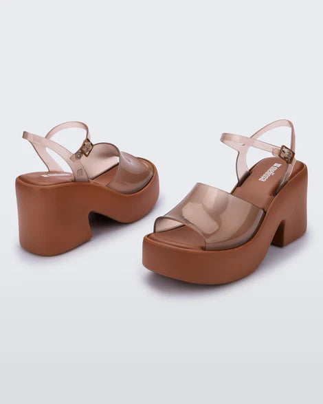 Brown platform sandal with translucent straps and buckle closure pair