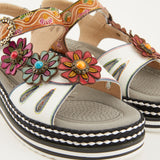 White sandal with colorful floral decorations and black & white sole pair close-up