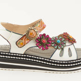 White sandal with colorful floral decorations and black & white sole close-up