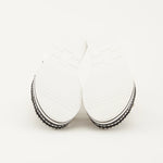 White sandal with colorful floral decorations and black & white sole sole view