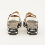 White sandal with colorful floral decorations and black & white sole heel view