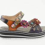 Black sandal with colorful floral decorations and black & white sole close-up