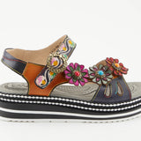 Black sandal with colorful floral decorations and black & white sole close-up