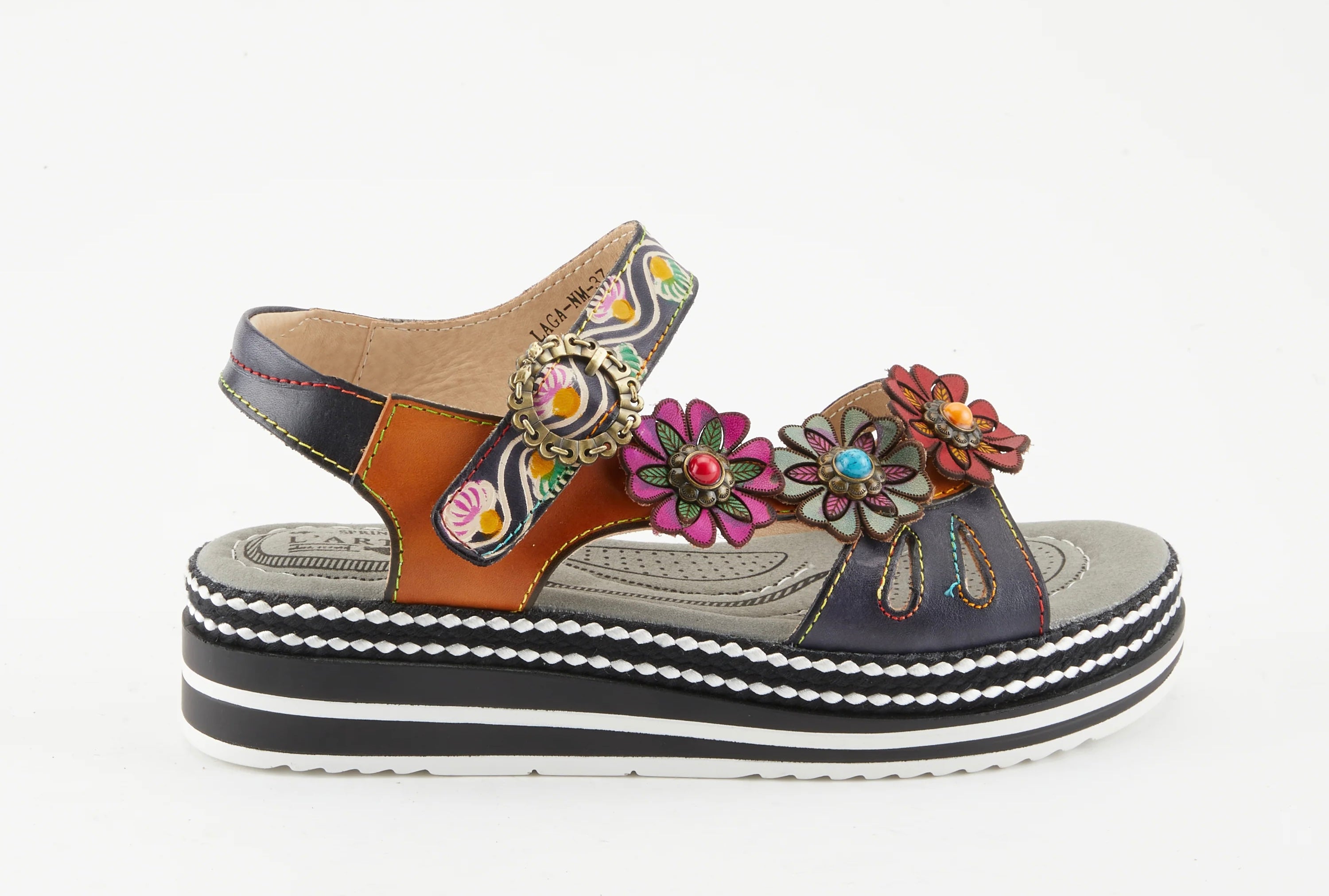 Black sandal with colorful floral decorations and black & white sole close-up