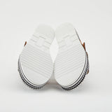 Black sandal with colorful floral decorations and black & white sole sole view