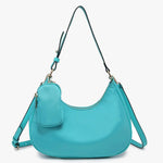 Turquoise handbag with a shoulder strap and hand strap and small accessory bag close-up