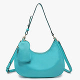 Turquoise handbag with a shoulder strap and hand strap and small accessory bag close-up