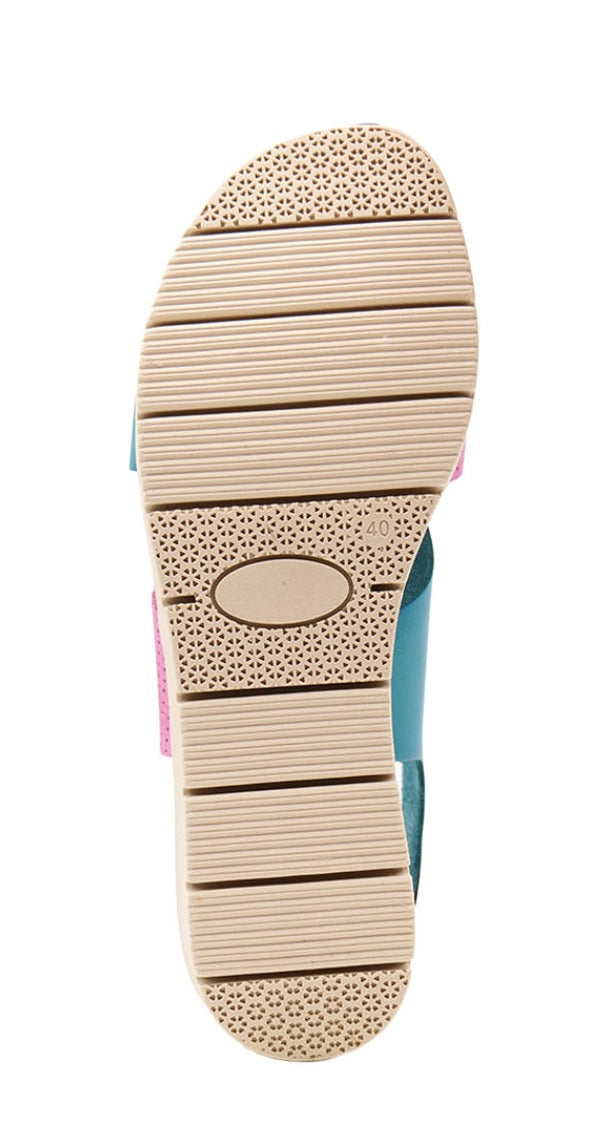 Pink and blue wedge with a beige sole, brown heel strap and buckle closure bottom view