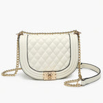 White quilted handbag with gold chain strap close-up