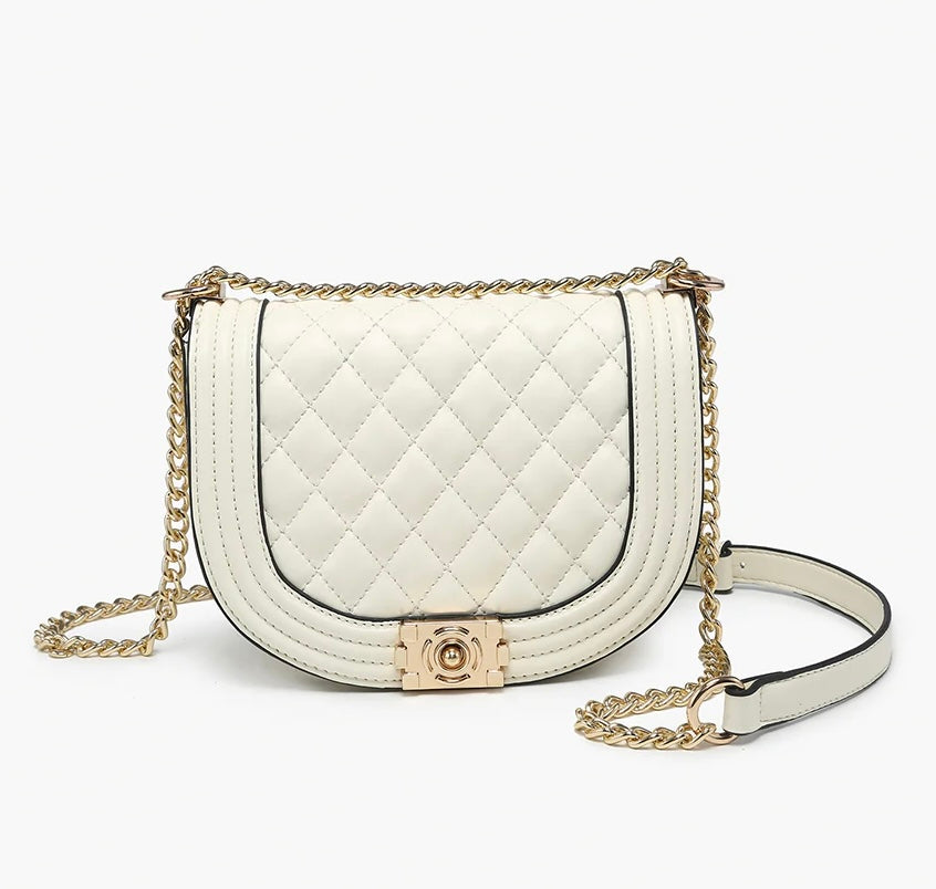 White quilted handbag with gold chain strap close-up