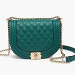 Green quilted handbag with gold chain strap close-up