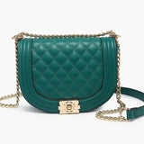 Green quilted handbag with gold chain strap close-up