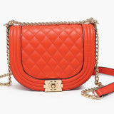 Orange quilted handbag with gold chain strap close-up