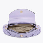 Lavender handbag with woven texture and gold accents top view