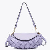 Lavender handbag with woven texture and gold accents close up