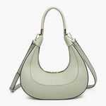 Light green handbag with a hand strap and shoulder strap close-up