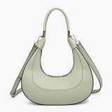 Light green handbag with a hand strap and shoulder strap close-up