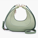Light green handbag with a hand strap and shoulder strap back