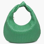 Green woven handbag close-up