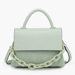 Light green handbag with a chain detail, hand strap and shoulder strap close-up