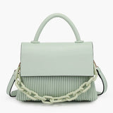 Light green handbag with a chain detail, hand strap and shoulder strap close-up