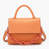 Orange handbag with a chain detail, hand strap and shoulder strap close-up