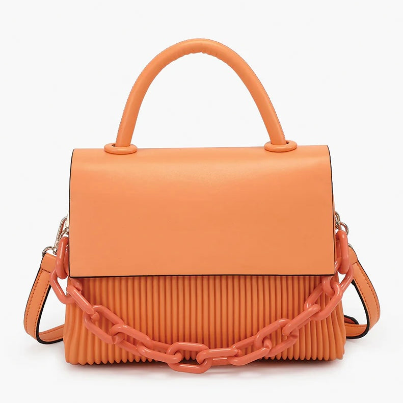Orange handbag with a chain detail, hand strap and shoulder strap close-up