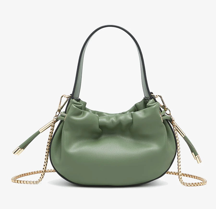 Green handbag with chain detail and hand strap close-up