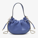 Blue handbag with chain detail and hand strap close-up