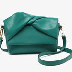 Green handbag with a bow design close-up