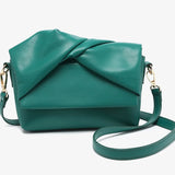 Green handbag with a bow design close-up