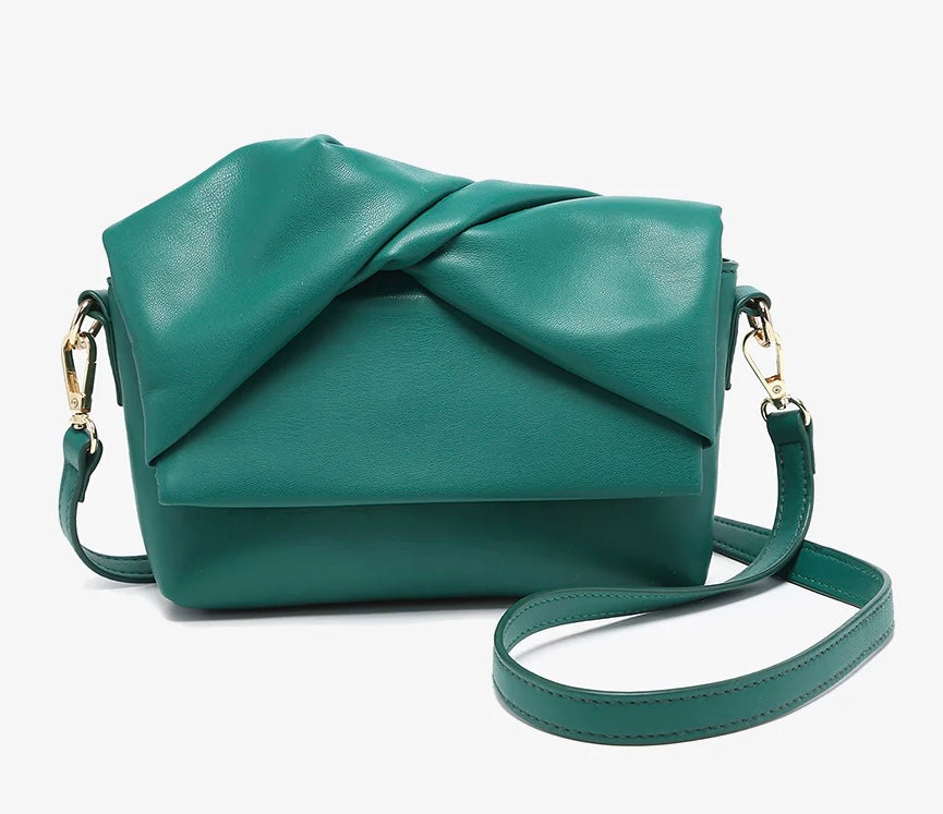 Green handbag with a bow design close-up